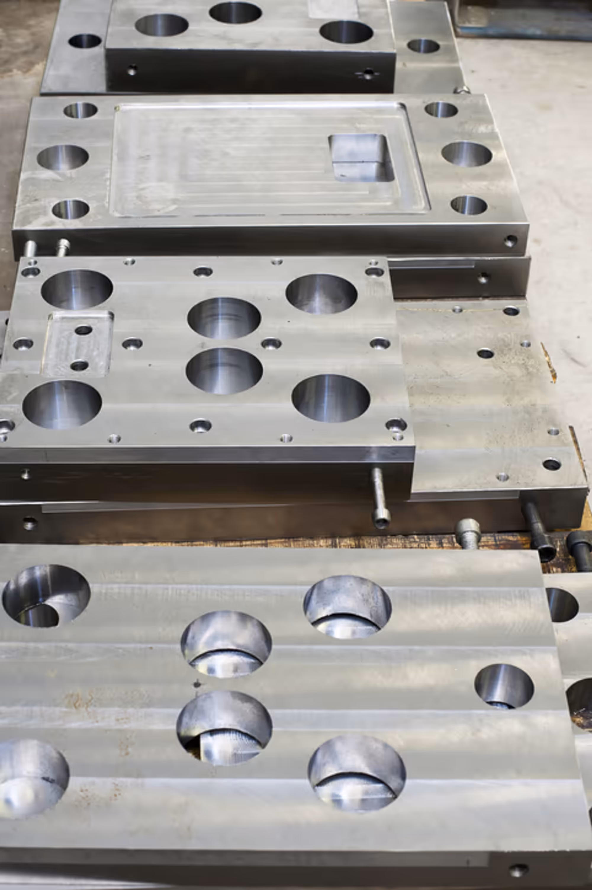 Machined steel blocks stacked in a works.